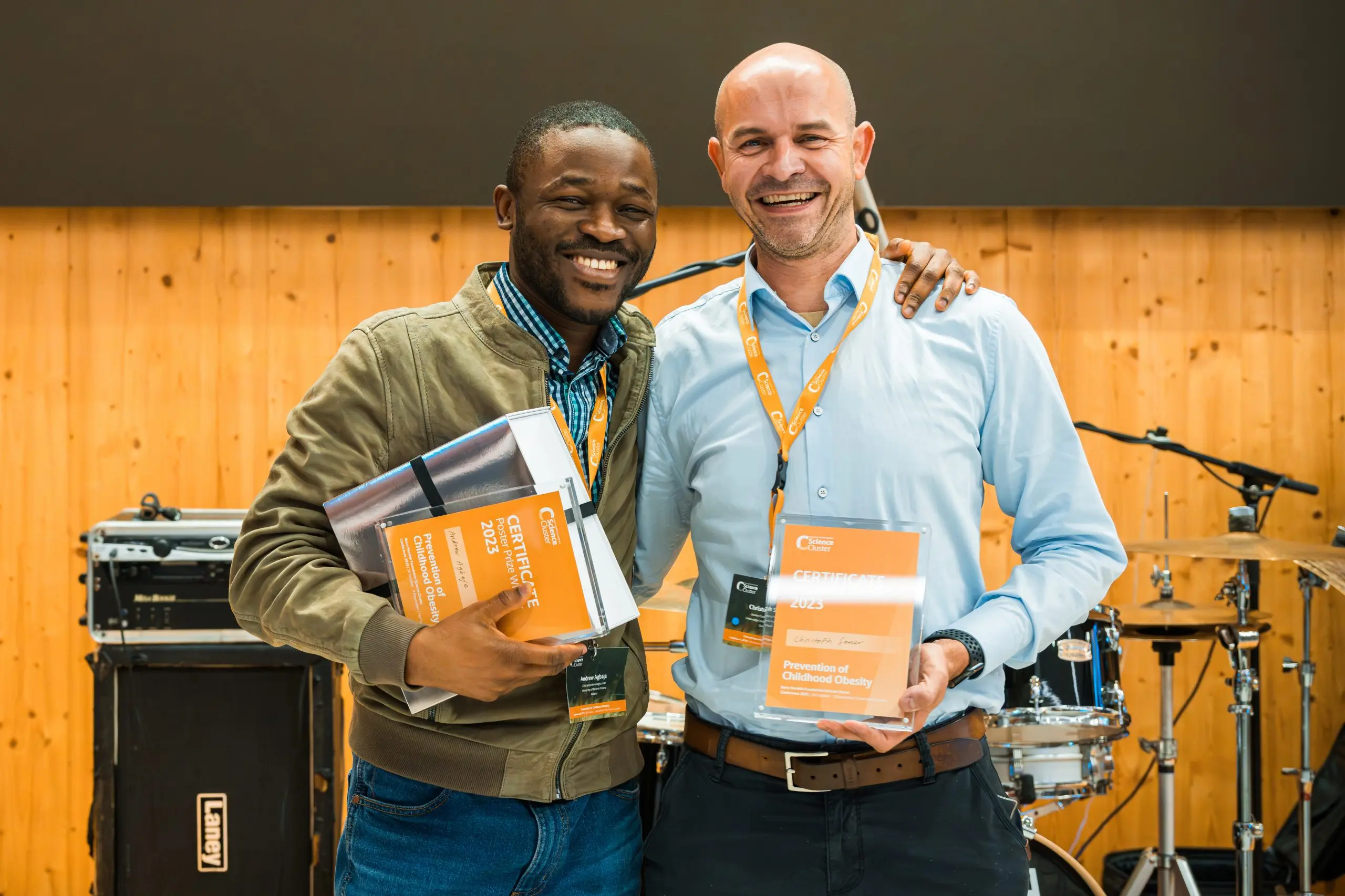 Prof Agbaje with Dr Christoph Saner at an award ceremony.